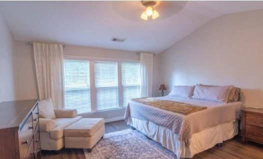 bedroom featuring vaulted ceiling, hardwood / wood-style floors, and ceiling fan