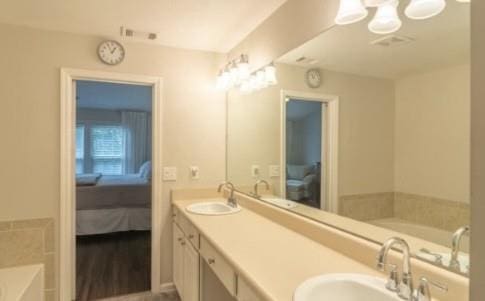 bathroom featuring vanity and a bath