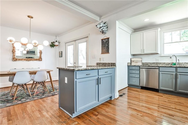 1136 Moreland Pl SE, Atlanta, GA 30316 - kitchen with dishwasher, a sink, light wood-type flooring, light stone counters, and ornamental molding