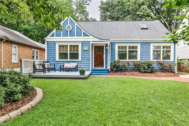 1136 Moreland Pl SE, Atlanta, GA 30316 - view of front of house with a front yard, an outdoor living space, a deck, and roof with shingles