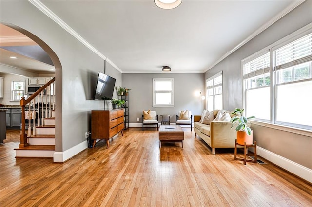 1136 Moreland Pl SE, Atlanta, GA 30316 - living area featuring light wood finished floors, ornamental molding, arched walkways, baseboards, and stairs