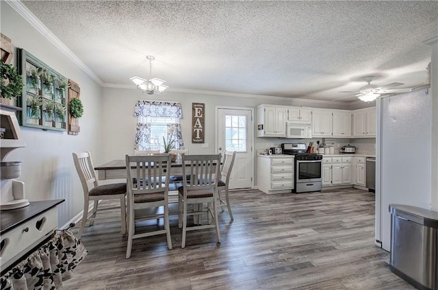 dining area featuring ornamental molding, ceiling fan with notable chandelier, a textured ceiling, and wood finished floors