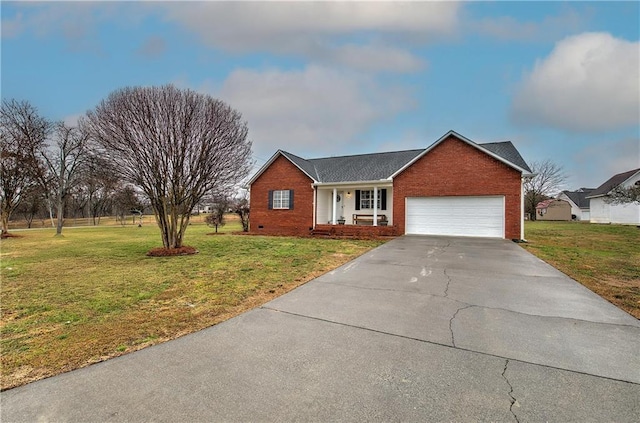 ranch-style house with driveway, brick siding, an attached garage, and a front yard