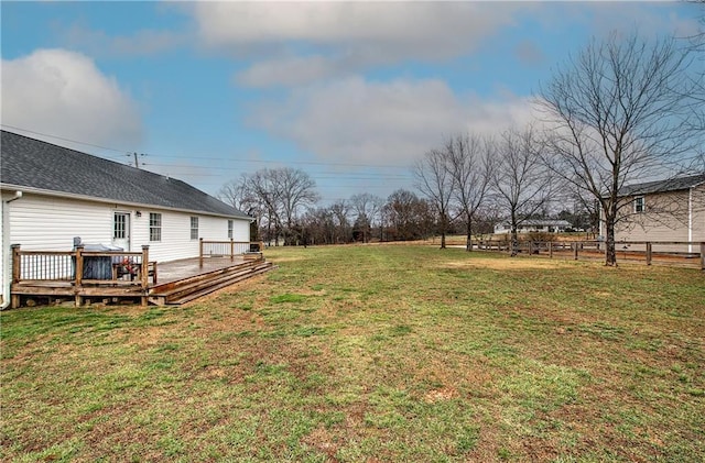 view of yard with fence and a deck