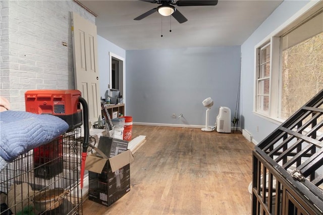 interior space with ceiling fan