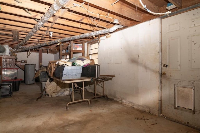 unfinished basement featuring water heater