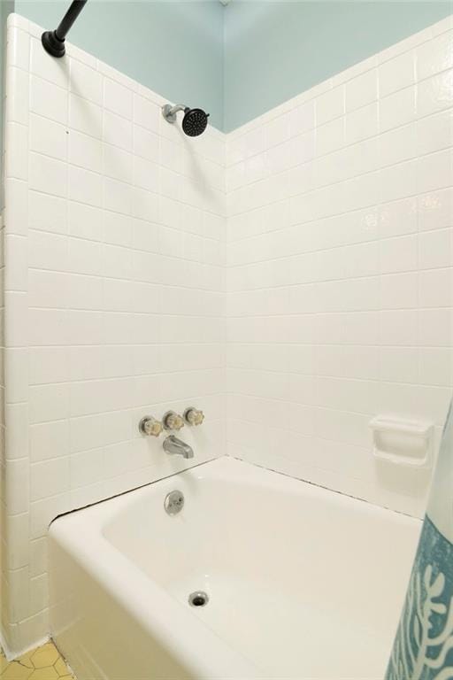 full bath featuring shower / bath combo and tile patterned floors