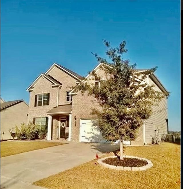 view of front facade featuring a front yard and a garage