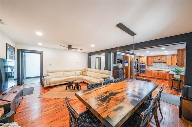 dining area featuring recessed lighting, ceiling fan, and light wood finished floors