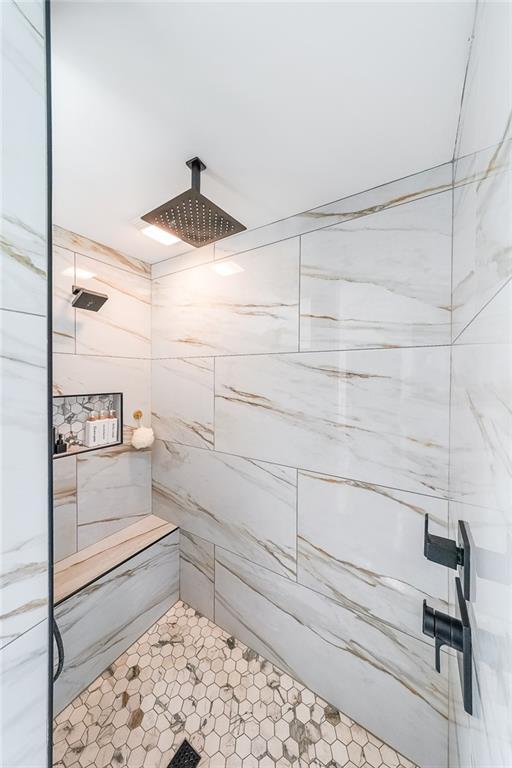 bathroom with a tile shower
