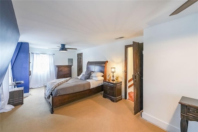 bedroom featuring baseboards, visible vents, light carpet, and ceiling fan