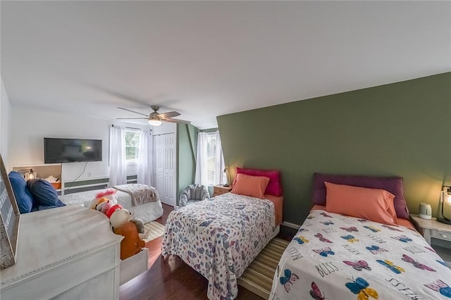 bedroom with wood finished floors, a ceiling fan, and a closet