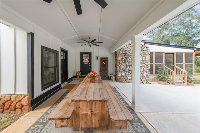 view of patio / terrace featuring a ceiling fan and a sunroom