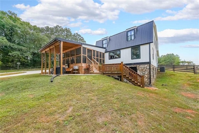 back of house with stairs, metal roof, central air condition unit, fence, and a yard