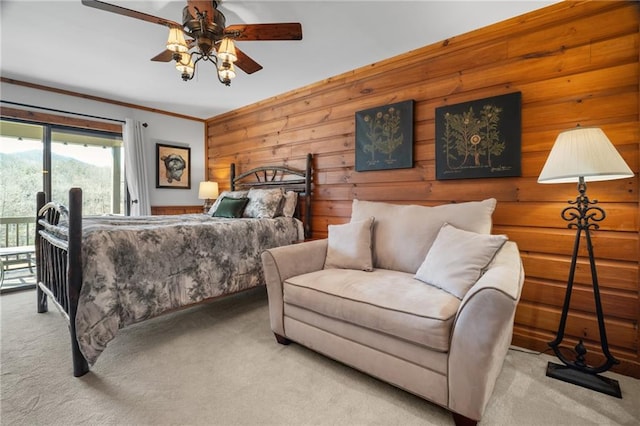 carpeted bedroom featuring crown molding, access to outside, and ceiling fan