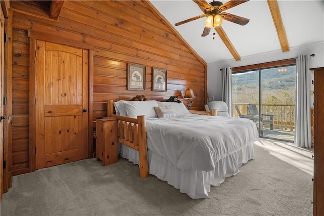 carpeted bedroom with beamed ceiling, high vaulted ceiling, a ceiling fan, wood walls, and access to exterior