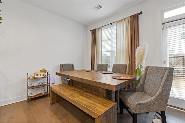 dining space featuring dark hardwood / wood-style flooring and a wealth of natural light