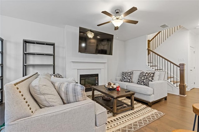 living room featuring hardwood / wood-style flooring and ceiling fan