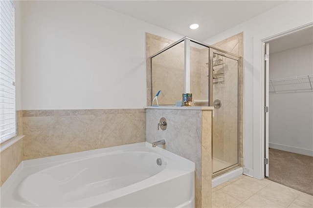 bathroom featuring tile patterned floors and separate shower and tub