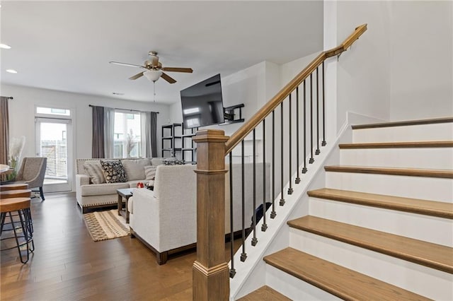 living room featuring ceiling fan and dark hardwood / wood-style flooring