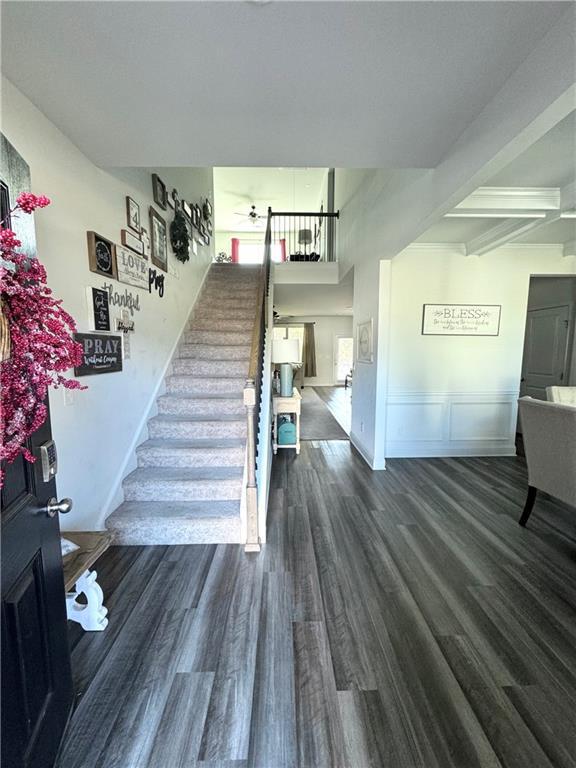 stairs with beam ceiling and wood-type flooring