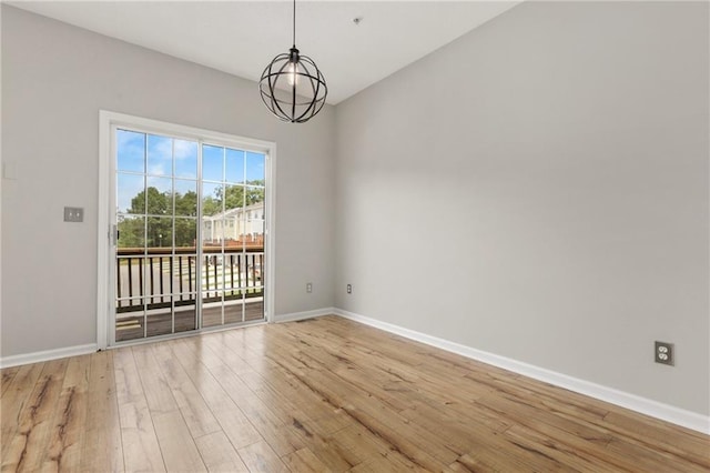 1122 Cotton Gin Dr, Woodstock, GA 30188 - empty room with light wood-style floors, baseboards, and a chandelier