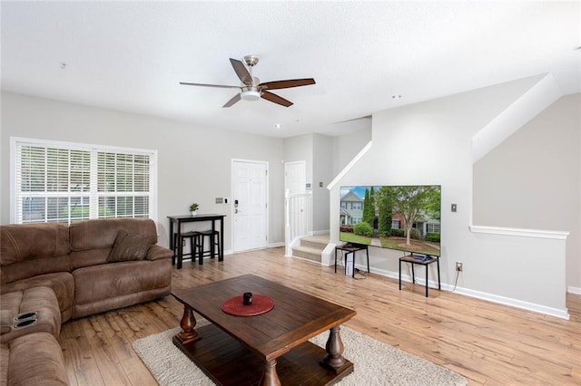 1122 Cotton Gin Dr, Woodstock, GA 30188 - living area with a ceiling fan, light wood-type flooring, baseboards, and stairs
