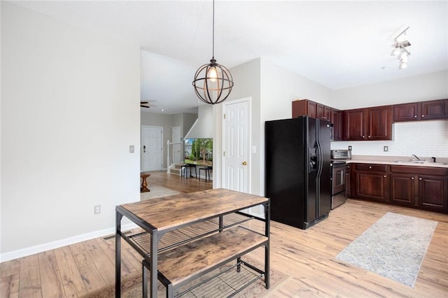 1122 Cotton Gin Dr, Woodstock, GA 30188 - kitchen featuring black refrigerator with ice dispenser, a sink, light wood-type flooring, light countertops, and baseboards