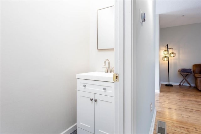 1122 Cotton Gin Dr, Woodstock, GA 30188 - bathroom with wood finished floors, baseboards, and vanity