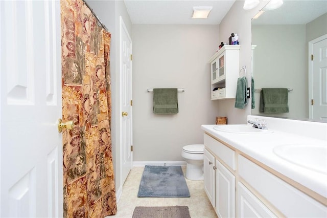 1122 Cotton Gin Dr, Woodstock, GA 30188 - bathroom with double vanity, toilet, tile patterned floors, and baseboards
