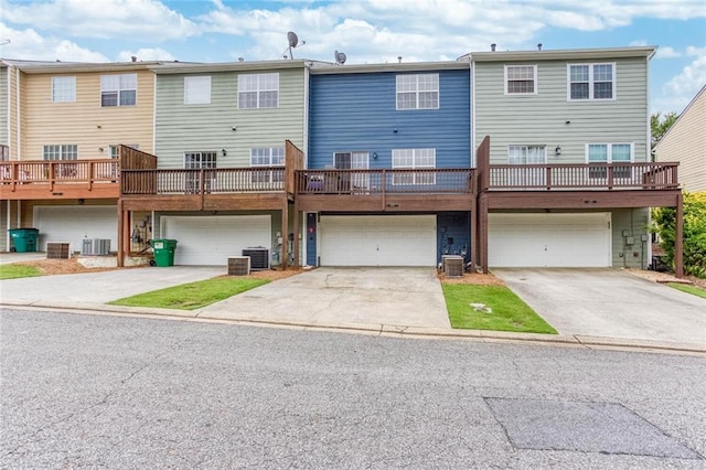 1122 Cotton Gin Dr, Woodstock, GA 30188 - back of house featuring a garage, central air condition unit, and driveway