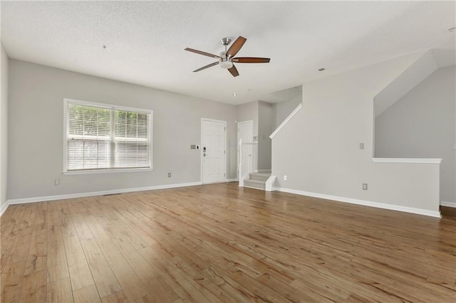 1122 Cotton Gin Dr, Woodstock, GA 30188 - unfurnished living room featuring a ceiling fan, wood-type flooring, stairway, and baseboards