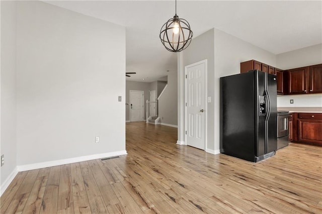 1122 Cotton Gin Dr, Woodstock, GA 30188 - kitchen featuring black fridge with ice dispenser, light wood-style floors, electric range oven, baseboards, and light countertops