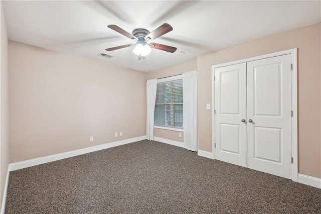 unfurnished bedroom with ceiling fan, a closet, and carpet