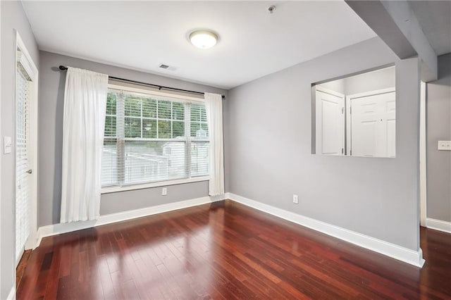 spare room featuring dark hardwood / wood-style flooring