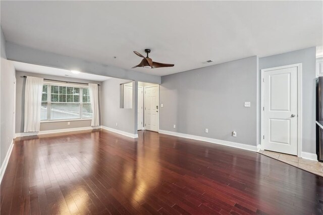 unfurnished living room with ceiling fan and hardwood / wood-style flooring