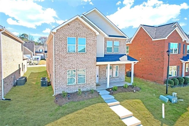 view of front of home with a front lawn, a porch, cooling unit, and brick siding