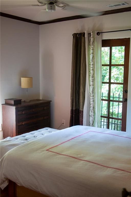 bedroom featuring visible vents and ornamental molding
