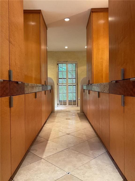 hall with recessed lighting and light tile patterned floors
