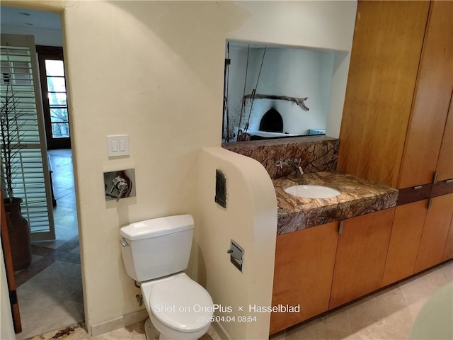 bathroom featuring toilet and vanity