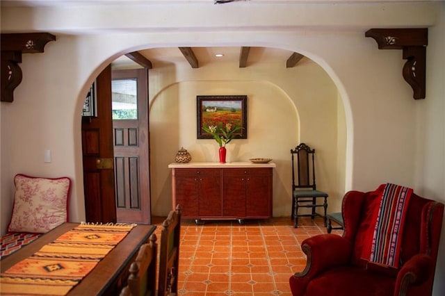 living area featuring arched walkways and light floors