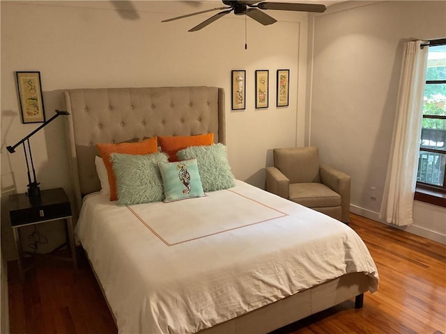bedroom featuring wood finished floors, ceiling fan, and baseboards