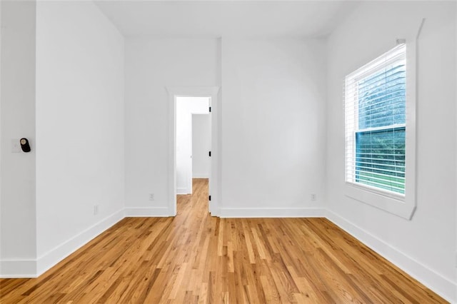 empty room with a wealth of natural light and light wood-type flooring