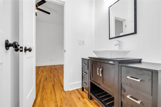 bathroom with wood-type flooring, vanity, and ceiling fan