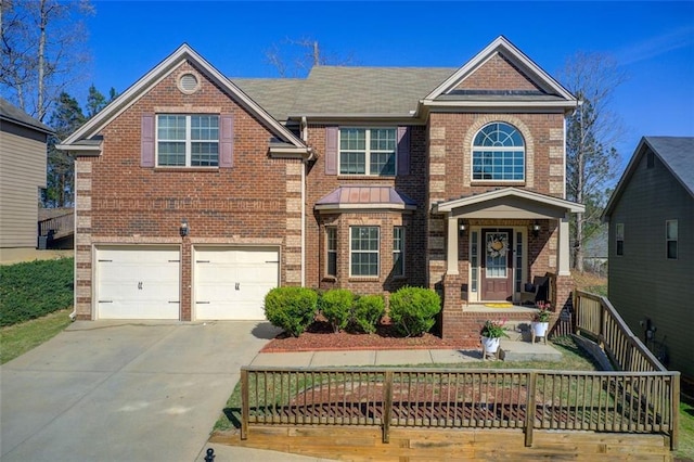 traditional-style house featuring brick siding, concrete driveway, and a garage
