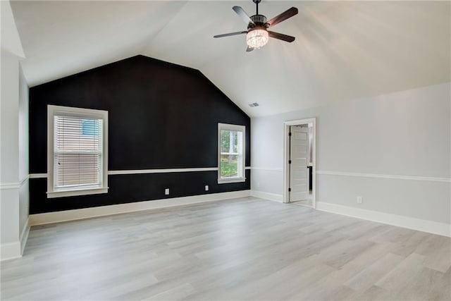 additional living space with light wood-style floors, a ceiling fan, lofted ceiling, and baseboards