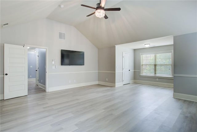 unfurnished living room with a ceiling fan, lofted ceiling, light wood-style floors, and baseboards