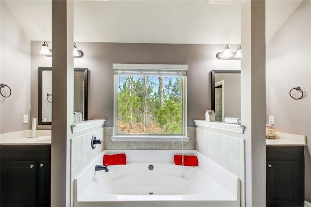 full bathroom featuring vanity and a garden tub