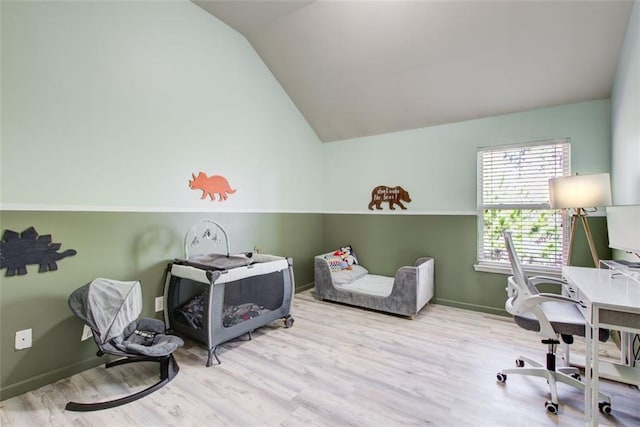 bedroom featuring a desk, vaulted ceiling, wood finished floors, and baseboards