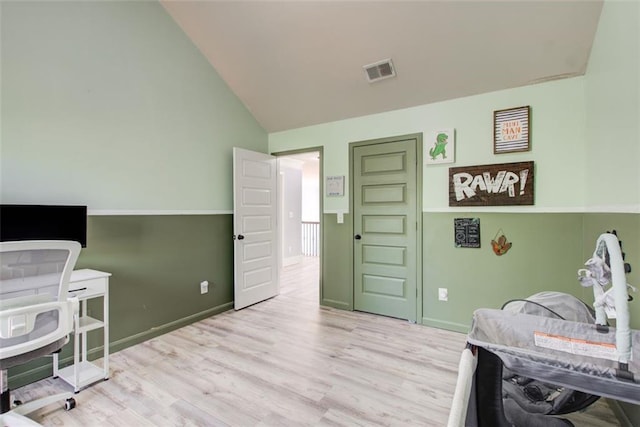 bedroom featuring wood finished floors, high vaulted ceiling, and baseboards
